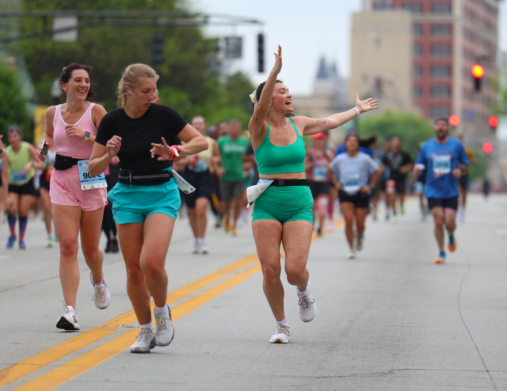 Runners wave to the crowd during Marathon.JPG